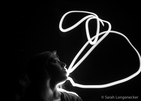 Woman blowing a bubble of light