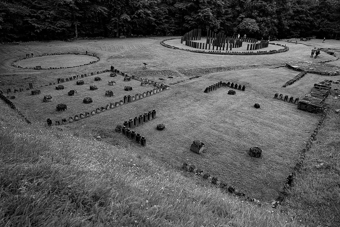 An overview shot of the Sarmizegetusa Regia ruins in black and white