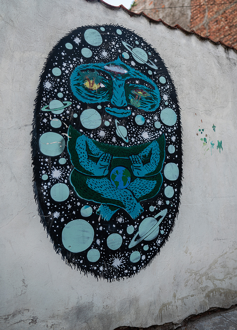 A mural of a hedgehog floating with planets and stars painted on it