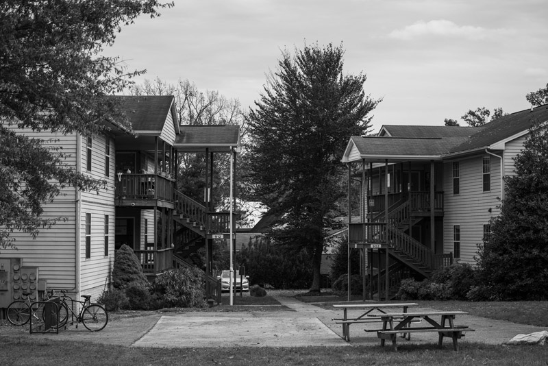 EMU residents sit together on the top floor of the apartments to talk, eat lunch, and enjoy the sunshine.