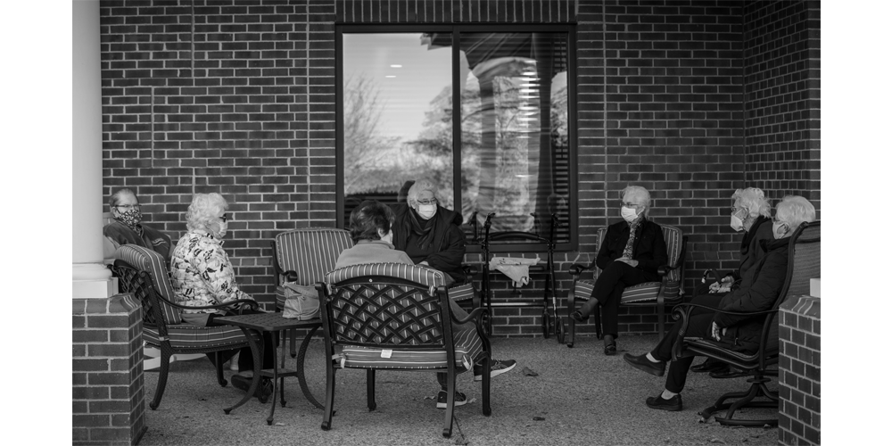 Residents at VMRC sit together to catch up and watch the goings on of the campus.